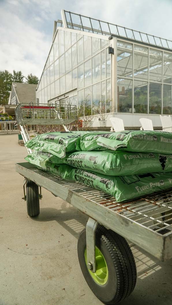 bags of compost on a shopping cart